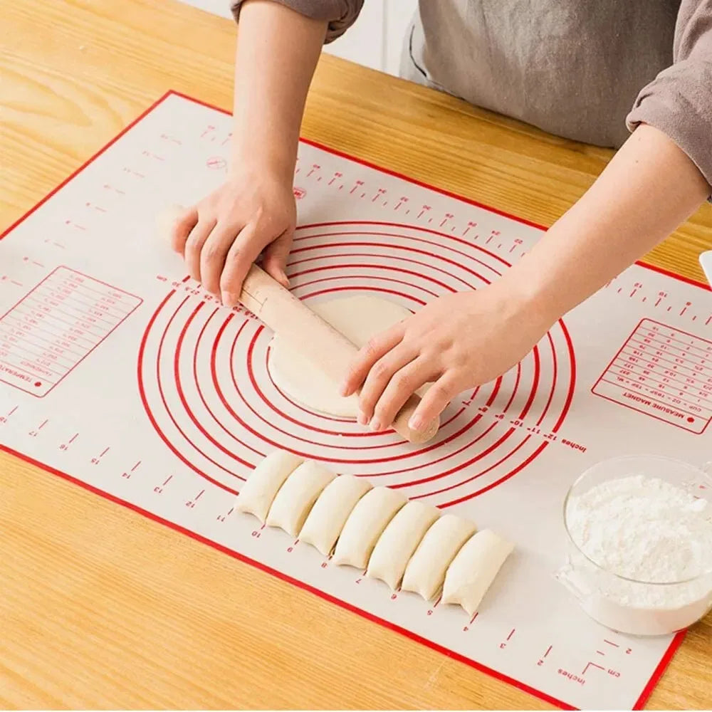 Silicone baking mat with red concentric rings and measurement lines, used for dough