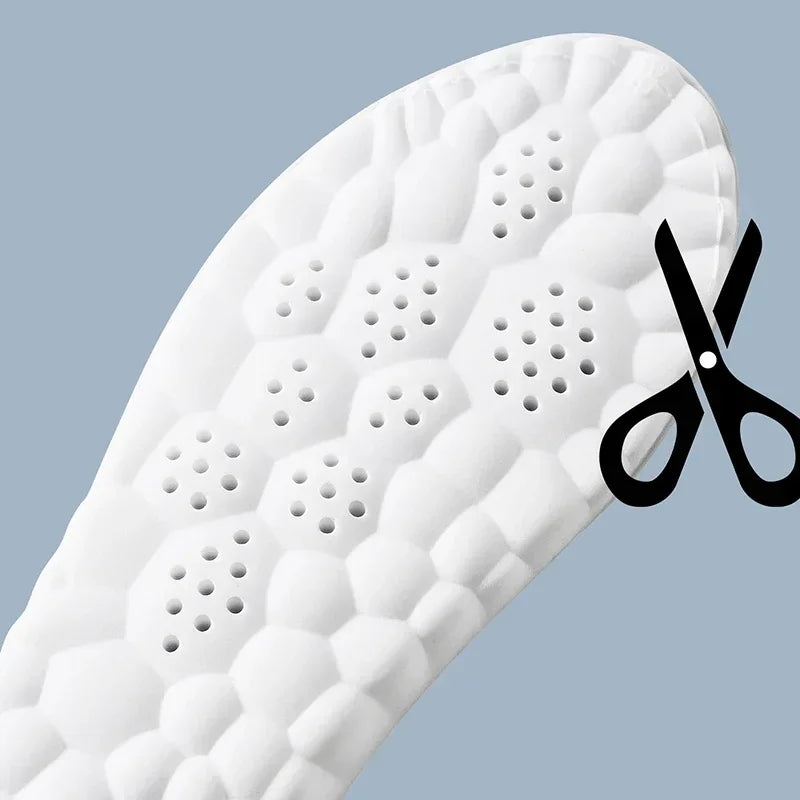 White running insole close-up with perforated ventilation dots across the arch
