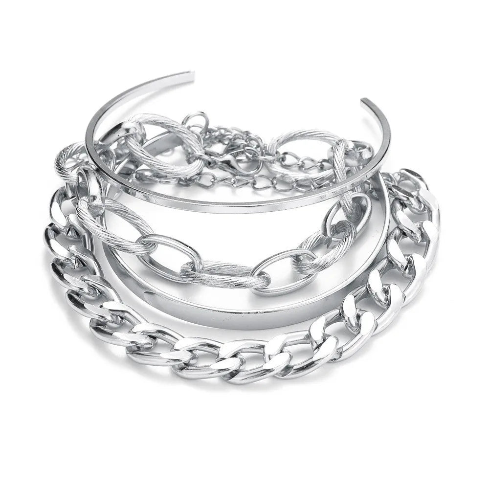 Silver-tone chain bracelet set with stacked bangles, chunky links, and oval accents