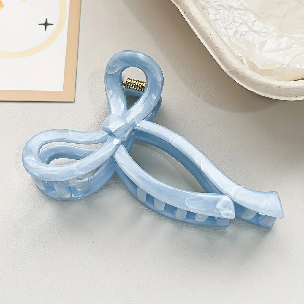 Light blue ribbon-style claw hair clip with gold center detail