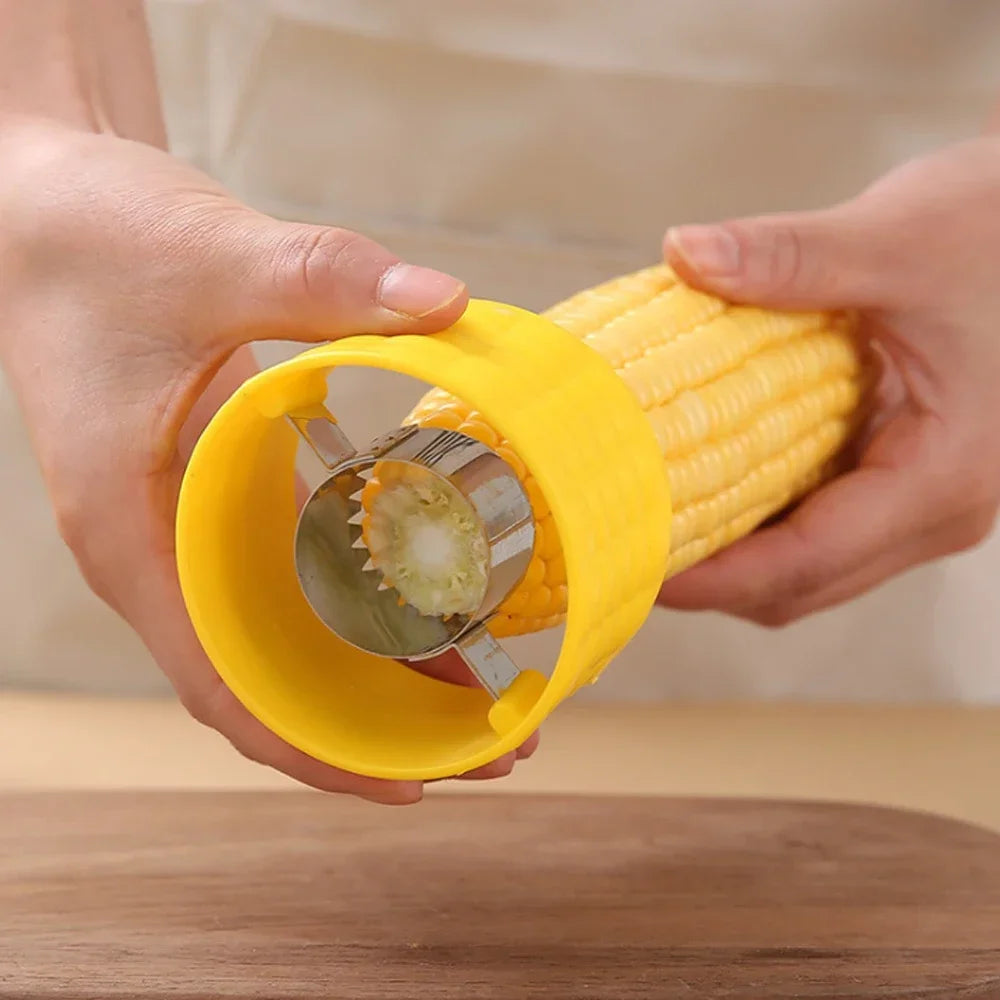 Yellow corn cob stripper peeler held in hands, serrated cutting wheel visible on cob.