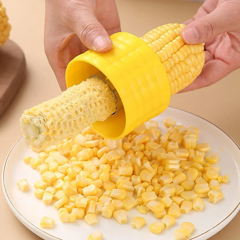 Yellow corn cob stripper peeler with serrated blade, pushing kernels into a plate.